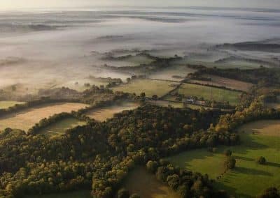 A Birdseye View of the Countryside With a Rolling Mist
